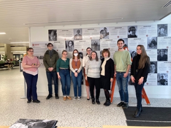 Organizers standing in front of the wall of diplomas